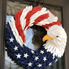 American Eagle Wreath red white and blue hanging on a brown door with a glass window in the door