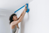 Person getting ready to paint the walls