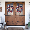 two 4th of july mesh wreaths on a door