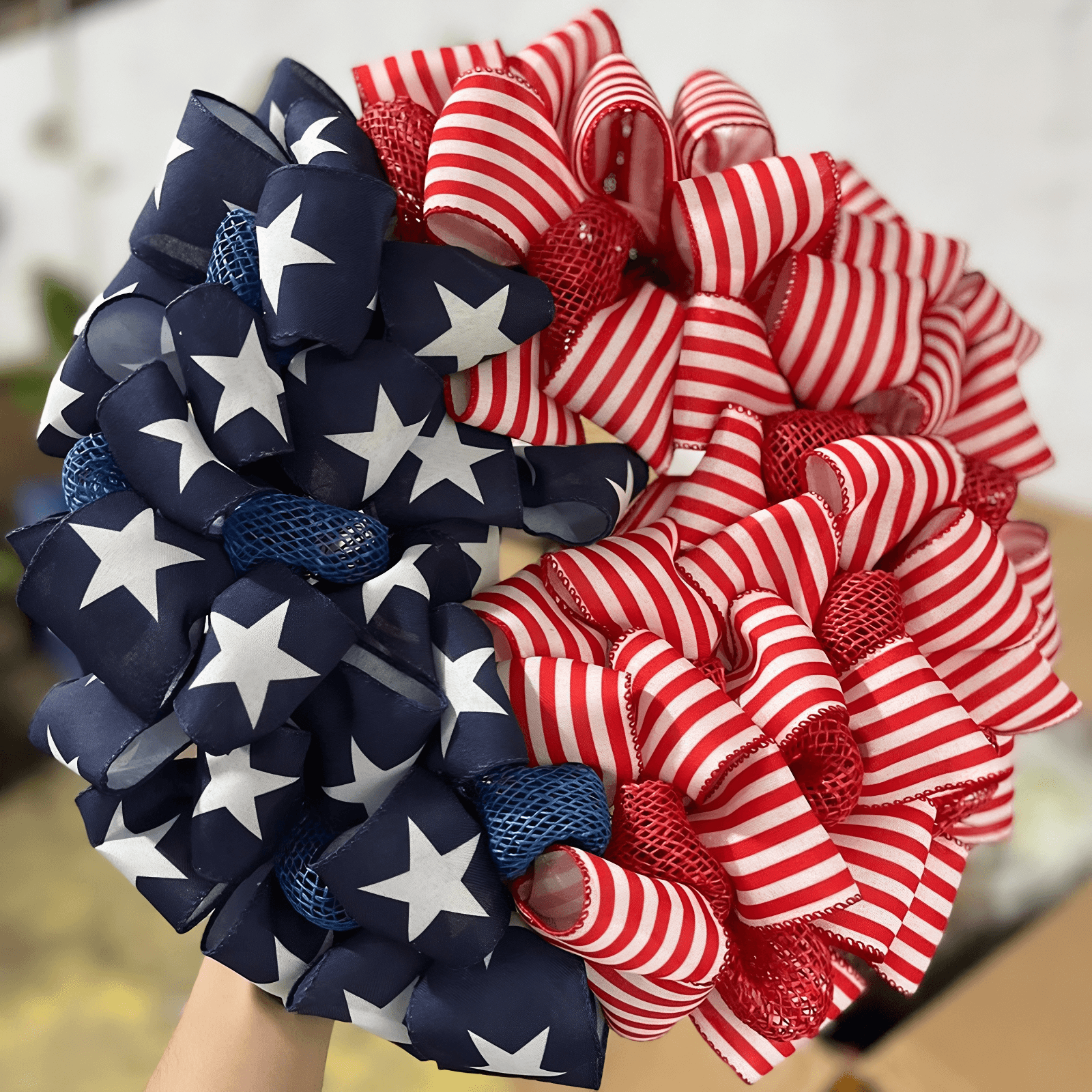patriot ribbon wreath in a hand