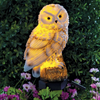 Solar garden owl that is turned on for the light to shine